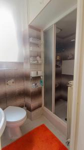 a small bathroom with a toilet and a shower at Lovely 5 min walk to Saint Peter Basilica in Rome