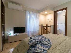a bedroom with a bed and a flat screen tv at A Due Passi dal Lago Welcomely in Tremezzo