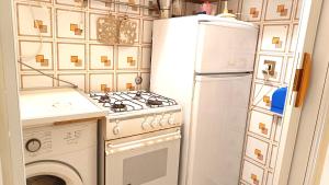 a kitchen with a stove and a refrigerator at Lovely 5 min walk to Saint Peter Basilica in Rome +25 photos
