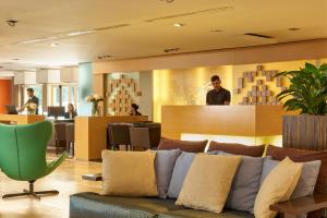 a living room with a couch and a bar at Almar Timi Ama Resort & Spa in Villasimius +37 photos