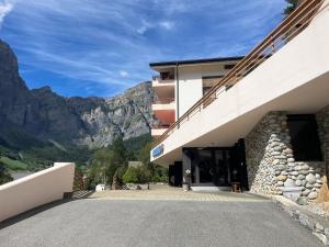 a building with a mountain in the background at Utoring 322 in Leukerbad