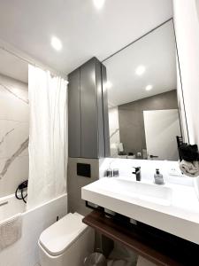 a bathroom with a white sink and a mirror at Royal Retreat - sarac Apartment in Bad Ischl +5 photos