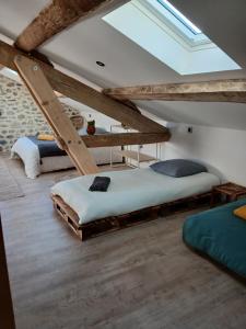 a bedroom with two bunk beds and a skylight at Les Gîtes du Saro in Chabestan