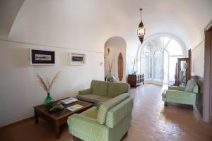 a living room with two couches and a table at Villa Puolo - Sorrento in Sorrento