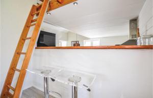 a ladder leading up to a room with a sink at Cozy Home In Ebeltoft With Sauna in Ebeltoft +22 photos