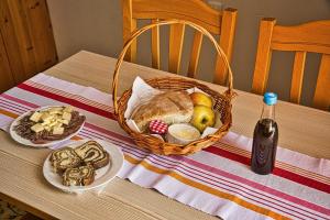 a table with a basket of bread and a bottle of wine at Farm Stay Ana in Višnja Gora