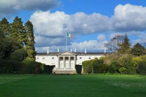 a white building with a flag on top of it at Central Dublin 2-Bed Apartment -Sleeps 5 & Parking in Dublin