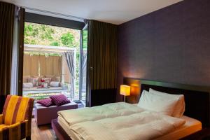 Letto o letti in una camera di Bad Bubendorf Design & Lifestyle Hotel