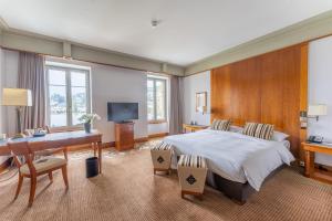 um quarto amplo com uma cama, uma secretária e um computador em Beau Rivage Hotel em Neuchâtel