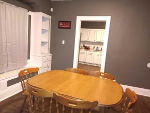 a dining room with a wooden table and chairs at Experience a home near Cleveland Clinic & parks in Cleveland +2 photos