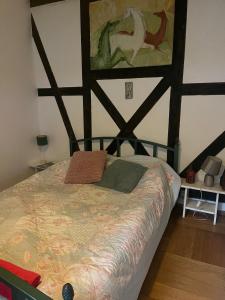 a bedroom with a bed with a wooden head board at Pokój Paw-puszcza kampinowska in Nowy Secymin