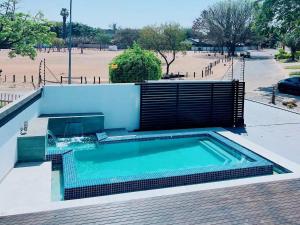 a swimming pool with a fence around it at The Guesthouse 8 On Impala in Polokwane