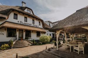 a building with a patio and a sign that reads shawshaw dog at Hotel Slamený Dom & SPA in Košice +18 photos