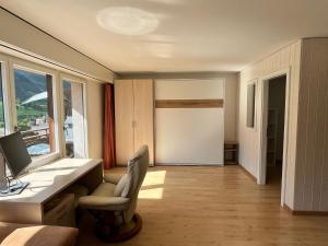 a room with a desk and a chair and a window at Utoring 322 in Leukerbad +33 photos