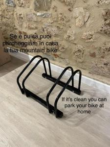 a metal bed frame in a room with a wall at La Casina del Corso in Massa Marittima