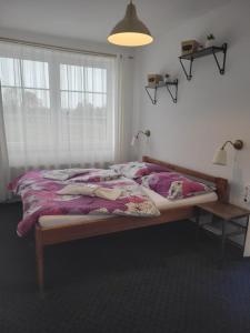 Postel nebo postele na pokoji v ubytování Pension Pastis