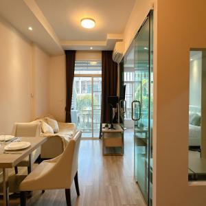 a living room with a dining table and a bedroom at Stylish room Near Central Fest in Chiang Mai