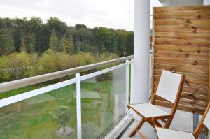 a chair on a balcony with a view at Westotel Life Nantes Carquefou in Carquefou