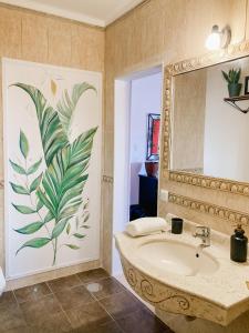 a bathroom with a sink and a mirror at In My House Baleal in Baleal