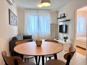 a living room with a table and a couch at Apartment Family in Zagreb