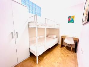 a bedroom with a bunk bed and a desk at Apartment Family in Zagreb +29 photos