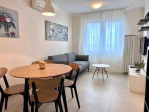 a living room with a table and a couch at Apartment Family in Zagreb