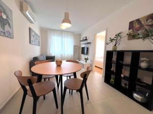 a living room with a table and chairs in a room at Apartment Family in Zagreb