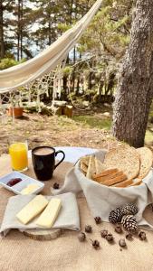 una mesa con pan y queso y una taza de zumo de naranja en Lo Nuestro Hotel Casa Campestre Villa de Leyva, en Villa de Leyva