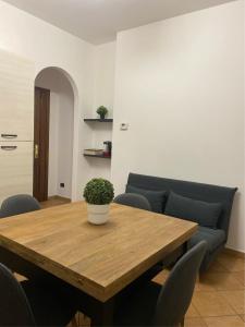 a living room with a wooden table and a couch at Little House in Fiumicino