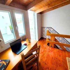 a laptop computer sitting on a wooden desk in a room at 4-bedroom Townhouse with Terrace in Center Oldtown in Lagos