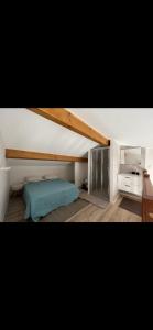 a bedroom with a bed and a vaulted ceiling at Appartement Oriana in Montegrosso
