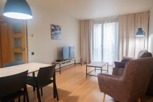 Televízia a/alebo spoločenská miestnosť v ubytovaní Apartments Hotel Sant Pau