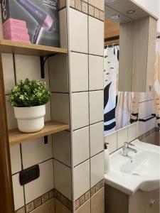 a bathroom with a sink and a mirror at Little House in Fiumicino