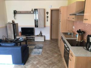 a kitchen and living room with a couch and a table at KELLer Ferienwohnung in Kell