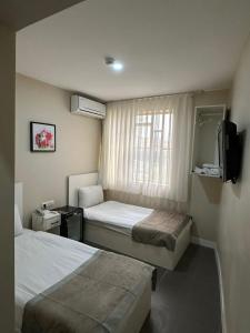 Postel nebo postele na pokoji v ubytování Rota Star Hotel Beyoğlu