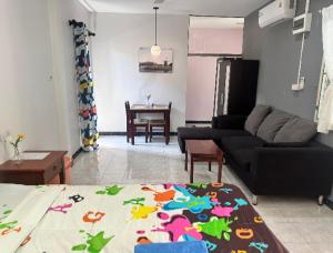 a living room with a couch and a table at Bangtoa room with kitchen near Lotus MMA & Beach in Bang Tao Beach