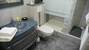 a bathroom with a sink and a toilet and a tub at Little Suite - Nathan in Lille +12 photos