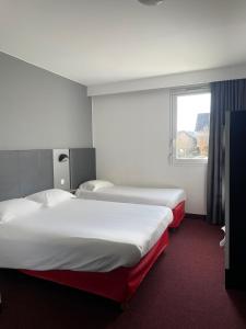 Postel nebo postele na pokoji v ubytování Brit Hotel Marvejols