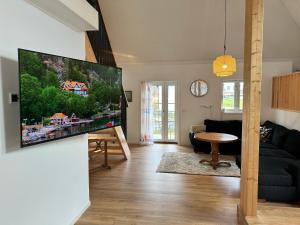 a living room with a large flat screen tv on the wall at Moderne Wohnung :: traumhafte Natur in Moholm