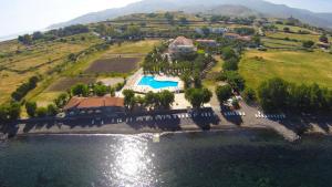 an aerial view of a house on a hill by the water at Aphrodite Hotel in Mythimna
