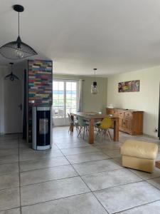 a living room with a table and a dining room at Les pieds dans la vallée in Châtillon-sur-Marne