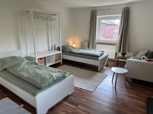 a living room with two beds and a couch at Ferienwohnungen Bahnhof Marxgrün in Naila