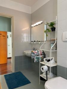 a bathroom with a sink and a toilet and a mirror at Bnbook -Bilo Malpensa 3 in Gallarate