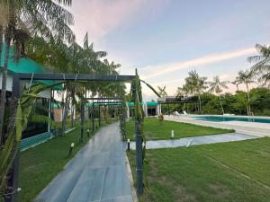 a resort with a swimming pool and palm trees at Villa'S Roraima in Boa Vista
