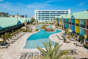 an aerial view of a resort with a pool and chairs at Beachside Hotel & Suites Cocoa Beach - Port Canaveral in Cocoa Beach