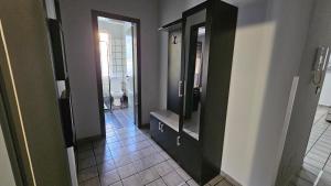 a bathroom with a black cabinet and a toilet at Mani's Family Lake Home in Tirana +43 photos
