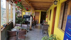 a patio with chairs and a table in a building at Suites Bella vista in Campos do Jordão
