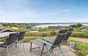 a group of chairs and a table on a patio at Holiday Home Sardinvej With Fireplace And Shower in Ebeltoft +30 photos