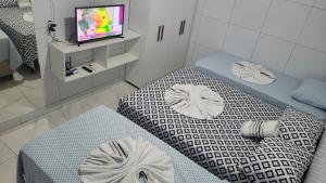 Postel nebo postele na pokoji v ubytování Suite Pajuçara