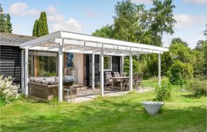 a pavilion with a table and a grill in a yard at 2 Bedroom Beautiful Home In Gilleleje in Gilleleje +23 photos
